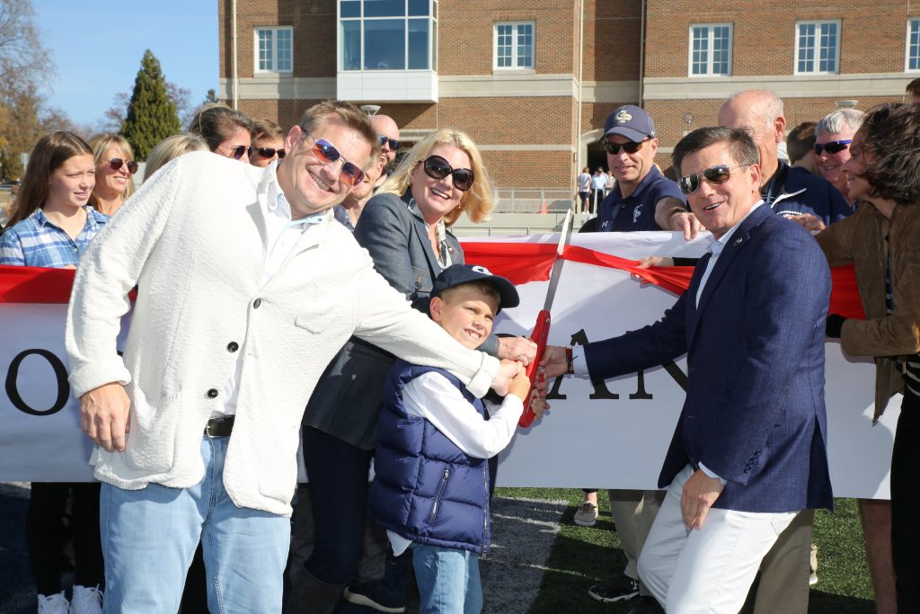 Ribbon-cutting ceremony with the Bidwill family, Tim ’90, Nicole, Michael ’83, Tim’s son Morgan